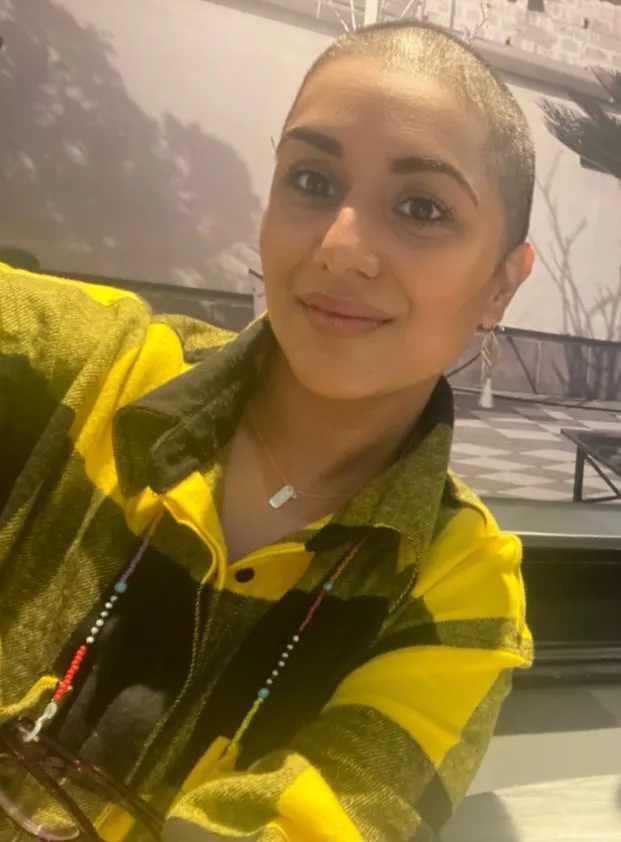 Amardeep Sirha, co-founder and Head of Data at amarti, smiling to camera in a yellow and green checked jacket